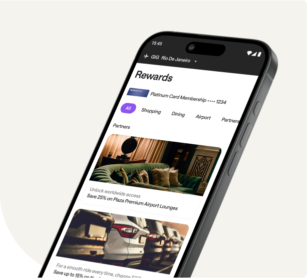 Close-up of a smartphone screen showing a 'Rewards' section of an app, possibly a Platinum Card membership. The screen shows tabs for 'All,' 'Shopping,' 'Dining,' and 'Airport,' and features a reward for '25% on Plaza Premium Airport Lounges.' The phone's status bar indicates the location is Rio de Janeiro.