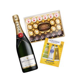 Ferrero Collection chocolate box displayed next to a Moët & Chandon champagne bottle and L'Occitane en Provence Soft Hands set, including three different hand creams.